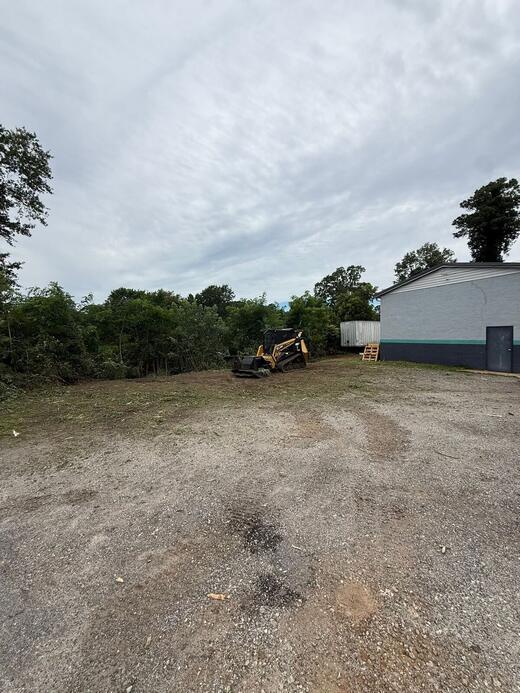 The same Pickens County lot after forestry mulching, opened back up around the outbuilding